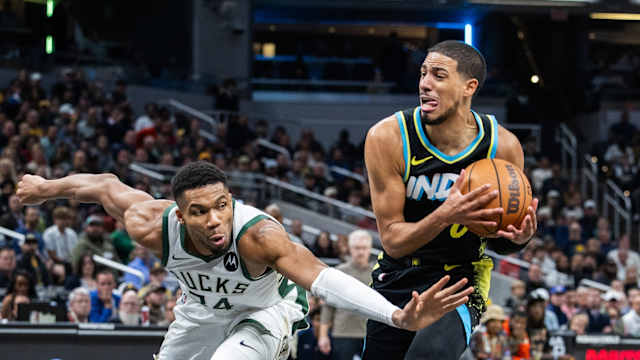 Indiana Pacers guard Tyrese Haliburton (0) dribbles the ball while Milwaukee Bucks forward Giannis Antetokounmpo (34) 